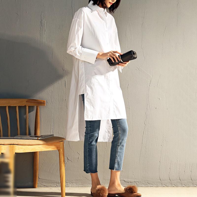 Long cotton blend button-up blouse/tunic. Hi-low hemline. Long sleeves with a turn down collar.